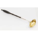 An early 19th Century Swedish silver / parcel gilt boat shaped ladle, turned handle, makers mark