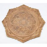 An Islamic copper plaque, pierced with moons and flowers, 37cm diameter.