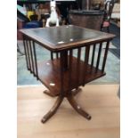 Revolving 20th Century bookcase with leather top on splayed legs, along with nest of three table