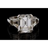 An emerald cut diamond solitaire platinum ring, the principal diamond weighing approx 5.86ozt,