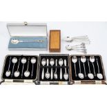 A collection of assorted silver tea and coffee spoons, comprising two sets of boxed coffee spoons,