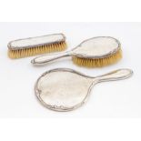 A George V silver three piece dressing table brush set, Birmingham 1926 comprising hair brush,