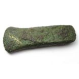 Bronze Age Axe.  Circa, 2000 BC. Copper-alloy, 68mm x 26mm x 9, 64.2g. A small cast bronze flat axe.