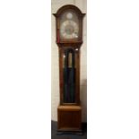 An early 20the century oak grandmother clock, the three train movement chiming upon gongs faced by