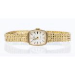 A 9ct gold ladies vintage Rotary quartz  watch, cushion shaped champagne dial with applied baton