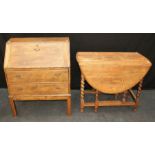 A 1920's oak barley twist drop flap table, 74 x 90 x 120cm(open), a small Edwardian oak bureau and a