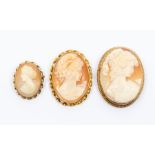 A collection of three 9ct gold mounted cameo brooches, the largest approx. 50 x 38mm, total gross