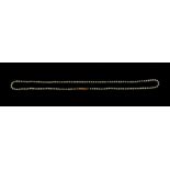 A small single row seed pearl necklace, strung knotted to a yellow metal engraved barrel clasp,