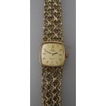 A lady's 9ct gold Omega wristwatch, the 1.5cm champagne dial with baton numerals, on a chain link