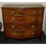 An early 19th century mahogany bow front chest of two short and three long graduated drawers with