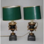 A pair of 19th century ebonised and gilt urns converted to lamps with shades. 55cm height overall,