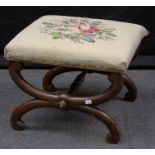 An early 19th century cross frame stool, with floral gros point upholstered seat