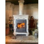 A Dovre woodburning stove with hand painted French floral ceramic tile surround and chimney piece,