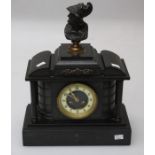 A 19th century black slate mantle clock with classical bust surmount over four column