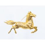 Horse interest- a 9ct gold brooch in the form of a galloping horse, length approx. 45mm, pin and