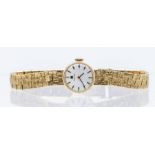 A 9ct gold ladies vintage Tissot  wristwatch, round silvered dial with applied baton markers,