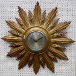 An early 20th century sunburst wall clock, the moulded giltwood case enclosing a silvered Arabic