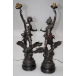 A pair of late 19th century bronzed spelter figures 'Jour and Nuit' adapted as lamps laid on