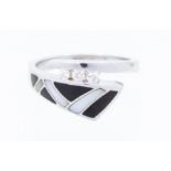 A diamond, onyx and mother of pearl 14k white gold dress ring, comprising a row of three graduated