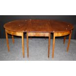 An early 19th century mahogany dining table, the two central sections with rectangular tops, flanked