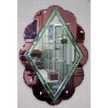 A 1930's cloud form wall mirror, the mauve peripheral plates enclosing clear lozenge glass with