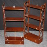 A pair of reproduction mahogany wall mounting open shelves, each with four tiers, quatrefoil open