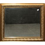 Brights of Nettlebed, a gilt composite wall mirror with moulded decoration and bevelled