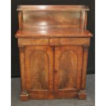 An early Victorian mahogany chiffonier, the shelved back over two frieze drawers and arched cupboard