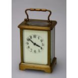 An early 20th century French carriage clock, the brass five glass case enclosing an eight day