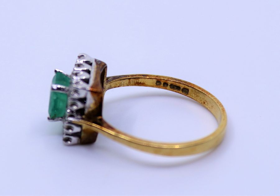 An 18ct emerald and diamond cluster ring, claw set emerald-cut emerald and fourteen eight-cut - Bild 3 aus 3