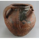 A large and impressive medieval earthenware three-handled vessel with pouring spout, c. 1500. It has