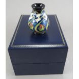 A twentieth century boxed Moorcroft vase decorated with a floral design. 5.5 cm tall. (1) Condition: