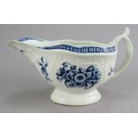 A late nineteenth century Worcester blue and white sauce boat, c. 1770. It is decorated with flowers