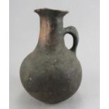 An early hand-thrown Roman earthenware jug with black finish, possibly first or second century. 20