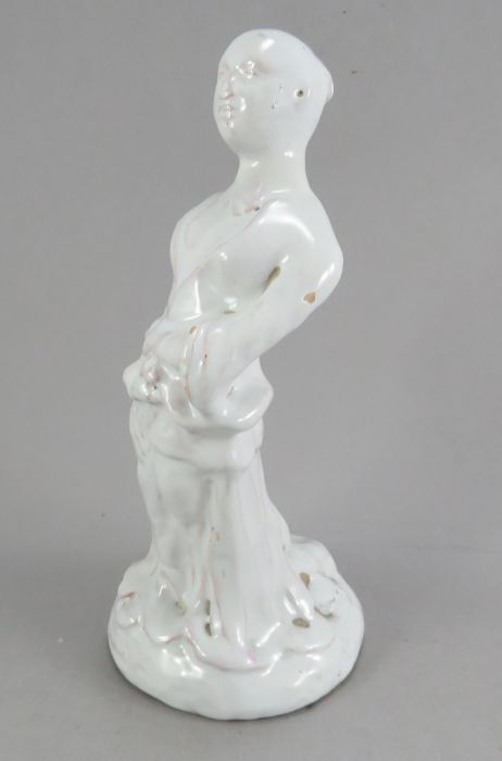 A late eighteenth, early nineteenth century tin glazed earthenware delft figure of a Chinse man,