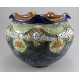 An early twentieth century Royal Doulton Lambeth jardiniere, c. 1900-10. It is decorated with face