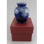 A twentieth century boxed Cobridge Pottery blue floral pattern vase. 10.5 cm tall. (1) Condition: In