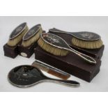A George V silver and tortoise shell dressing set comprising:- a mirror, a comb, two large brushes