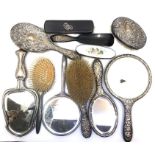 A collection of silver and silver plated dressing sets, comprising:- four mirrors (one with