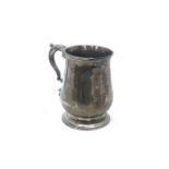 A George III silver baluster shaped tankard with leaf-capped flying scroll handle, maker T.W. London