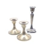 Two silver weighted dwarf candlesticks, 8.5cm tall, hallmarked Chester, 1930 together with a