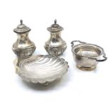 A collection of silver items comprising:- a scalloped shaped dish with glass liner, on three