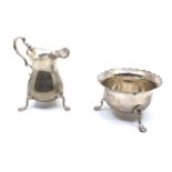 A Elizabeth II silver milk jug and sugar bowl, scalloped edge design raised on three pad feet, total