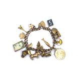 A 9ct. rose-gold curb link charm bracelet with padlock clasp with 14 various 9ct. charms, a pair