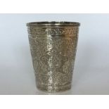A Persian (Iranian) 840 beaker, finely chased and engraved with floral and foliage decoration