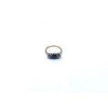 A three stone Ring, claw set 'black' faceted stone to the centre, old-cut diamond and further
