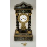 A French Empire portico clock, the gilt metal mounted ebonised wood case with vine bound barley