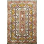 A mid 20th century Turkish Melas carpet, woven with geometric and symmetrical floral motifs on a