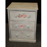 A late 19th century 'distressed' painted three drawer chest with knop handles and rose decoration,