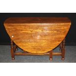 A good reproduction 18th century style oak drop leaf gateleg dining table, on bobbin turned and